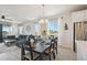 Dining room with a table set for six, light fixture, with an open floor plan to the living room at 171 S Waterloo St, Aurora, CO 80018