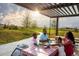 Gathering enjoys a picnic lunch together on a sunny day under a wooden shelter at 171 S Waterloo St, Aurora, CO 80018