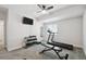 Functional home gym features a treadmill, weight rack, weight bench, and a ceiling fan at 171 S Waterloo St, Aurora, CO 80018