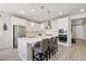 Modern kitchen with stainless steel appliances, a center island, and sleek white cabinetry at 171 S Waterloo St, Aurora, CO 80018