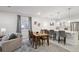 Open living space boasts a dining table and chairs next to the kitchen island with barstool seating at 171 S Waterloo St, Aurora, CO 80018