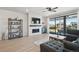 Spacious living area with a modern fireplace, shelving, and large sliding doors to an outdoor patio at 171 S Waterloo St, Aurora, CO 80018