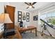 Bright office features a wood desk, wall decorations, telescope, and ceiling fan at 171 S Waterloo St, Aurora, CO 80018
