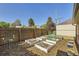 Fenced backyard featuring raised garden beds, wooden fence, and a bird bath at 2901 N Glencoe St, Denver, CO 80207