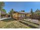 Spacious backyard featuring raised garden beds, a charming gazebo, and solar panels on the roof at 2901 N Glencoe St, Denver, CO 80207