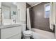 Well-lit bathroom with a modern vanity, a bathtub with shower, and clean, neutral tones at 2901 N Glencoe St, Denver, CO 80207