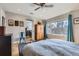 Bright bedroom with a ceiling fan, a large window, and a wardrobe for ample storage at 2901 N Glencoe St, Denver, CO 80207