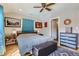 Cozy bedroom featuring an inviting bed, a stylish chest of drawers, and a ceiling fan at 2901 N Glencoe St, Denver, CO 80207