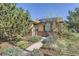 Inviting home exterior with manicured front yard, lovely landscaping, and brick accents at 2901 N Glencoe St, Denver, CO 80207
