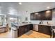 Open kitchen with stainless steel appliances, granite counters, and adjacent dining area at 2901 N Glencoe St, Denver, CO 80207