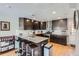 Updated kitchen boasts granite counters, dark cabinetry, and breakfast bar with seating at 2901 N Glencoe St, Denver, CO 80207