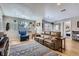 Cozy living room with a comfortable leather sofa, accent chair, and large windows at 2901 N Glencoe St, Denver, CO 80207