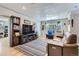 Inviting living room featuring a stylish patterned rug, comfortable seating, and a built-in bookcase for storage at 2901 N Glencoe St, Denver, CO 80207