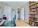 Functional office space with a desk, a comfortable chair, and ample storage in the bookcase at 2901 N Glencoe St, Denver, CO 80207