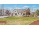 Large, grassy backyard with patio and view of the house's exterior from yard at 20271 E Lake Ave, Centennial, CO 80016
