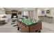 Stylish staged basement with foosball table, sofa, bar stools and entertainment area at 20271 E Lake Ave, Centennial, CO 80016