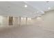 Unfinished basement area with carpet, support columns, and stairs leading to the main floor at 20271 E Lake Ave, Centennial, CO 80016