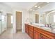 Bathroom showcasing granite countertops, dual sinks, and walk-in shower with decorative tile flooring at 20271 E Lake Ave, Centennial, CO 80016