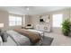 Bright bedroom showcasing neutral walls, white trim, modern furniture, and large windows that create a serene atmosphere at 20271 E Lake Ave, Centennial, CO 80016