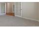 Bright bedroom with neutral carpet flooring and a door to a separate room at 20271 E Lake Ave, Centennial, CO 80016