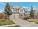 Charming two-story home features an attached two-car garage and a well-maintained front yard with mature trees at 20271 E Lake Ave, Centennial, CO 80016