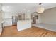 Open-concept kitchen and living area with stainless steel appliances, hardwood floors and lots of natural light at 20271 E Lake Ave, Centennial, CO 80016