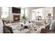 Staged living room features a brick fireplace, natural light, and a smooth transition to the kitchen and dining area at 20271 E Lake Ave, Centennial, CO 80016