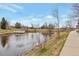 Scenic pond view with a small deck and walking path. A serene outdoor space within the community at 20271 E Lake Ave, Centennial, CO 80016
