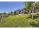 Expansive backyard features lush lawn, mature trees, and play equipment at 5350 Clearbrooke Ct, Castle Rock, CO 80104