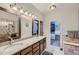 Bathroom features a double sink vanity, large mirrors, and a walk-in closet for ample storage space at 5350 Clearbrooke Ct, Castle Rock, CO 80104