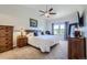 Vaulted ceiling main bedroom with a large window, ceiling fan, and an elegant wooden dresser at 5350 Clearbrooke Ct, Castle Rock, CO 80104