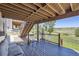 Covered deck boasts wood flooring, metal railings, and views of a grassy backyard at 5350 Clearbrooke Ct, Castle Rock, CO 80104