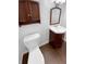 Half bathroom featuring modern fixtures, a pedestal sink, and wood-look flooring at 10707 Milliken St, Parker, CO 80134