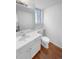 This bathroom has a large mirror, wood-look flooring and a white vanity with plenty of storage at 10707 Milliken St, Parker, CO 80134