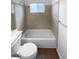 Bathroom with a combined tiled shower and tub, toilet, and white walls, offering a clean and refreshing look at 10707 Milliken St, Parker, CO 80134