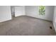 Spacious bedroom features a large window for natural light and neutral carpeting at 10707 Milliken St, Parker, CO 80134