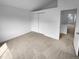 Spacious carpeted bedroom featuring a sliding closet and an attached open room, perfect for relaxing at 10707 Milliken St, Parker, CO 80134