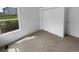 Carpeted bedroom with natural light, closet, and neutral color palette, making it feel cozy and bright at 10707 Milliken St, Parker, CO 80134