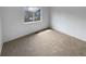 This carpeted bedroom is bright with a neutral color palette and offers a calm space at 10707 Milliken St, Parker, CO 80134
