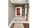 Home's inviting red front door entryway with brick and siding details at 10707 Milliken St, Parker, CO 80134
