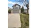 Two-story home featuring a gray exterior with a two-car garage and well-maintained front yard, offering curb appeal at 10707 Milliken St, Parker, CO 80134