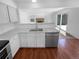 Modern kitchen with stainless steel appliances, granite countertops, and white cabinetry at 10707 Milliken St, Parker, CO 80134