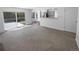 Bright living room with a neutral color palette, new carpet, and sliding door to the backyard at 10707 Milliken St, Parker, CO 80134