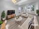 Bright, virtually staged living room featuring high ceilings, many windows, and modern decor at 10707 Milliken St, Parker, CO 80134