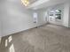 A spacious living room with carpet, high ceilings, and many windows at 10707 Milliken St, Parker, CO 80134