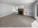 Bright living room with a brick fireplace, built-in shelving and sliding glass door at 10707 Milliken St, Parker, CO 80134