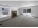 Cozy living room with a brick fireplace and access to the outdoor patio at 10707 Milliken St, Parker, CO 80134