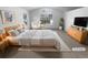 A bright and airy main bedroom with a king size bed and a large window at 10707 Milliken St, Parker, CO 80134