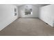 A empty carpeted room with a large window at 10707 Milliken St, Parker, CO 80134