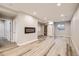 Spacious basement living area with modern fireplace and sliding barn door at 15437 W 95Th Ave, Arvada, CO 80007